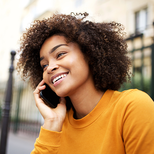 Woman smiles and chats on the phone