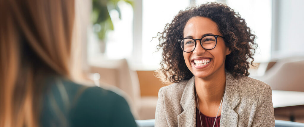 Woman smiles while talking to therapist