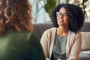 Woman smiles while talking to therapist in a therapy program